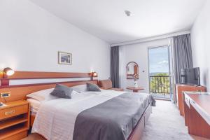 Posteľ alebo postele v izbe v ubytovaní Hotel Horizont