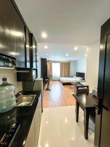a kitchen with a sink and a living room at Ann apartment in An Khê