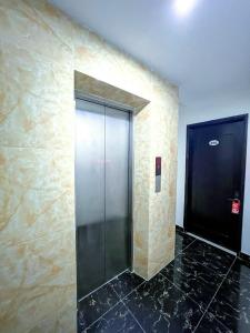 a elevator in a building with a black tile floor at Ann apartment in An Khê