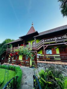 a house with a yellow at Casa de vacanță Trei Zâne in Sovata