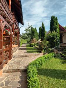 a garden path next to a brick building at Casa de vacanță Trei Zâne in Sovata