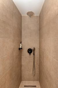 a bathroom with a shower with a shower head at White City Stay in Thessaloniki