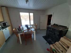 una cucina e una sala da pranzo con tavolo e sedie di Willa Stonehill a Iisalmi