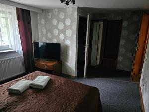a bedroom with a bed with two towels on it at "Zacisze" in Zgierz