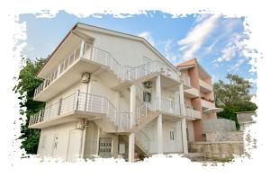 a large white building with white balconies on it at Vila Varagic in Budva