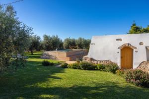 a building with a door in a yard at Tenuta Solentino in Ugento