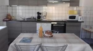 a kitchen with a table with a cake on it at Gite le figuier de l'ill in Sélestat
