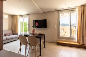 a living room with a dining room table with chairs and a window at At home in Clermont, Place de Jaude in Clermont-Ferrand