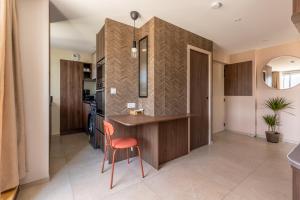 a kitchen with a desk and a chair in a room at At home in Clermont, Place de Jaude in Clermont-Ferrand