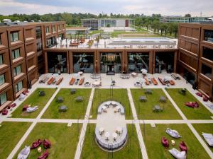 an aerial view of a building with a courtyard at TRIBE Milano Malpensa in Vizzola Ticino