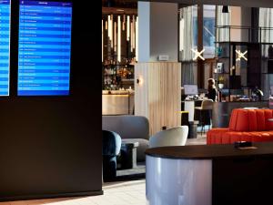 a restaurant with a table and chairs and a bar at TRIBE Milano Malpensa in Vizzola Ticino