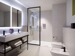 a bathroom with a shower and a sink and a toilet at TRIBE Milano Malpensa in Vizzola Ticino