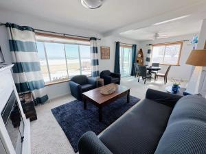 a living room with a couch and a table at Charming Lake Huron Cottage Private Beach Access in Oscoda