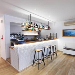a kitchen with two bar stools and a counter at Villa Serena in Lido di Jesolo