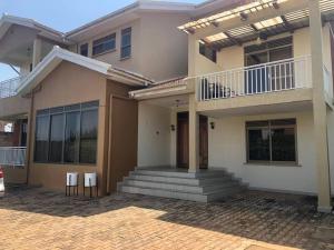 een huis met twee stoelen ervoor bij Bridges incorporated limited in Entebbe