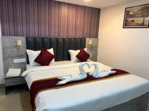 Postel nebo postele na pokoji v ubytování Hotel Orchard Park