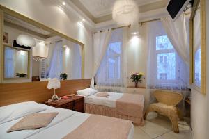 a hotel room with two beds and a mirror at Bulgakov Apartments in Moscow