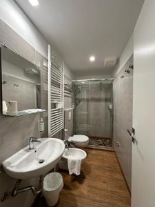 a bathroom with a sink and a toilet and a shower at Hb Hotels Orchidea Blu in Rimini