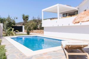 a villa with a swimming pool and a house at La Villa Pura Vida San Diego - Luxury Villa with Wonderful Sea View - Direct walking access to beach! 5 min from Sotogrande in San Roque