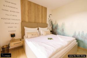 a bedroom with a bed with a poster on the wall at Vitalpension Bad Blumau - ADULTS ONLY in Bad Blumau +19 photos