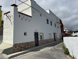 a white building on the side of a street at New modern apartment, Scandinavian style, ocean view, huge terrace in Icod de los Vinos