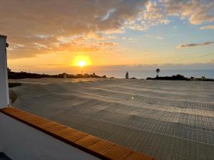 a view of the sunset from the roof of a building at New modern apartment, Scandinavian style, ocean view, huge terrace in Icod de los Vinos