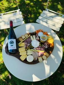 a plate of food with a bottle of wine at Cocon Bourguignon in La Motte-Saint-Jean +11 photos