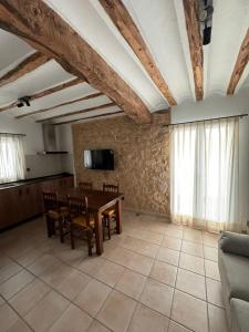 a living room with a table and a couch at Casas rurales de La Fuente in Villora
