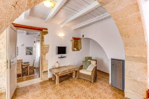 a living room with a table and a chair at Villa Epavlis by Villa Plus in Plaka