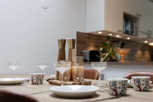 a table with plates and glasses on top of it at Aurora Row House in Rovaniemi