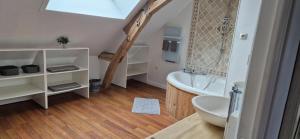 a bathroom with a white tub and a sink at Ma Demoiselle d'Oé - maison climatisée -3 étoiles in Notre-Dame-dʼOé +51 photos