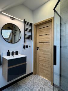 a bathroom with a sink and a mirror at Domek DE-Luxe BUFLAK in Nowy Targ +38 photos