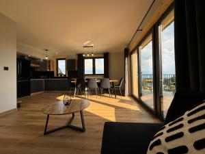a living room with a couch and a table at Domek DE-Luxe BUFLAK in Nowy Targ