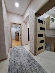 a room with a hallway with a door and a rug at Center of Gebele Castel in Gabala