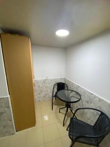 a small table and a chair in a room at Дом в старом тбилиси in Tbilisi City