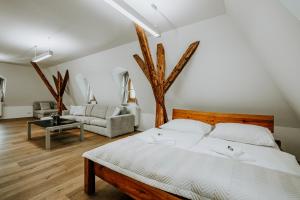 a bedroom with a bed and a living room at Penzión Banský dom in Banská Štiavnica