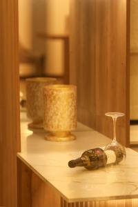 a table with two wine bottles and a wine glass at The Grand Bliss, Luxurious Modern Villa with Spacious Private Garden, Swimming Pool, Gym, and Free Wi-Fi in Kottawa