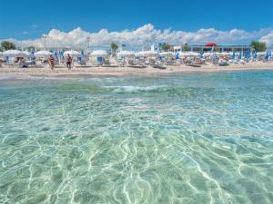 a view of a beach with chairs and umbrellas at Tramonti salentini in San Marzano di San Giuseppe