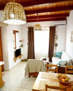 a living room with a table and a couch at Guest house Dimitra in Sitia +18 photos