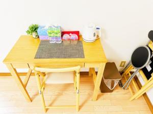 a wooden table with a chair in a room at メゾンドリバージュ205 in Tokyo