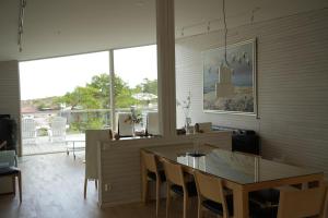 a living room with a table and a dining room at HavsVidden Resort in Geta