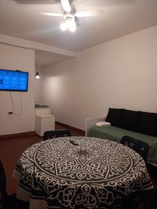 a living room with a table and a couch at Casa Eusebio - Catamarca capital in San Fernando del Valle de Catamarca