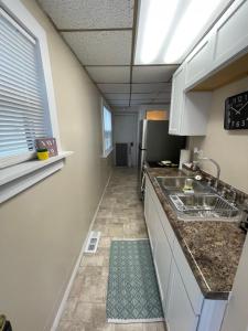 a kitchen with a sink and a counter top at Magnolia APT 1 in Lansing +2 photos