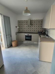 a kitchen with a sink and a stove at Donna Cecilia in Santa Maria al Bagno