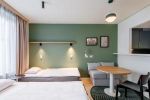 a hotel room with a bed and a table at Aparthotel Adagio Muenchen City in Munich