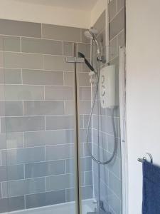 a shower with a shower head in a bathroom at Portsmouth House near Centre 3 Bedrooms in Portsmouth +22 photos