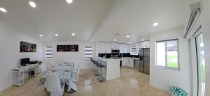 a white salon with a table and chairs in a room at Sunny Oasis with private pool in Homestead