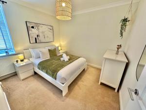 a bedroom with a bed with a teddy bear on it at Family Three Bedroom Home - Outbuilding Games Room - Walk to Town and Beach - Free Parking in Bournemouth