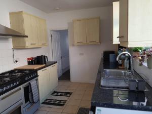 a kitchen with a sink and a stove top oven at Portsmouth House near Centre 3 Bedrooms in Portsmouth