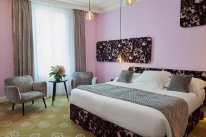 a bedroom with a large bed and a pink wall at Hotel Le Negresco in Nice